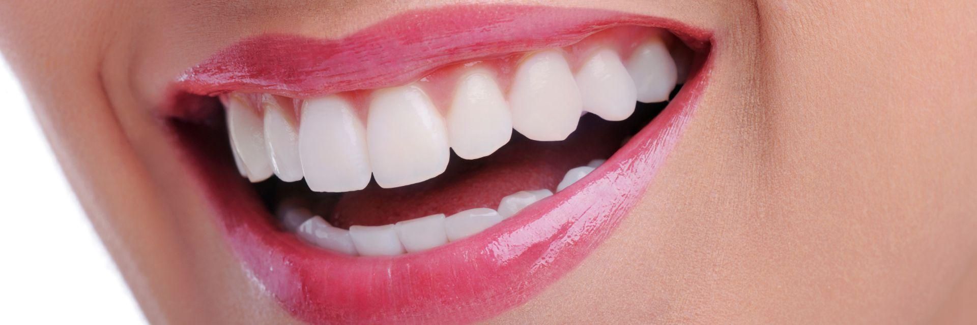 The radiant smile of a woman with pink lipstick